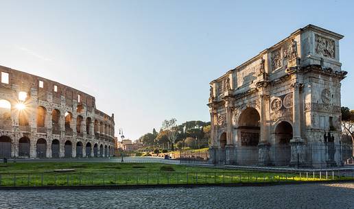 Colosseum at sunrise with the Arch of Constantine