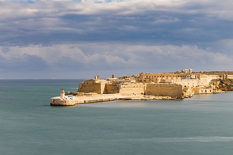 Lighthouse breakwater and defenses of Fort Rikasoli, Valletta, Malta Lighthouse breakwater and defenses of Fort Rikasoli, Valletta, Malta