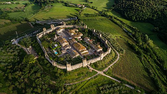 Aerial view of Monteriggioni village. It is a complete walled medieval town in the Siena Province of Tuscany built in the 13th century, Italy, Europe Aerial view of Monteriggioni village. It is a complete walled medieval town in the Siena Province of Tuscany built in the 13th century, Italy, Europe