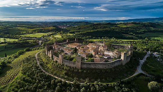Aerial view of Monteriggioni village. It is a complete walled medieval town in the Siena Province of Tuscany built in the 13th century, Italy, Europe Aerial view of Monteriggioni village. It is a complete walled medieval town in the Siena Province of Tuscany built in the 13th century, Italy, Europe
