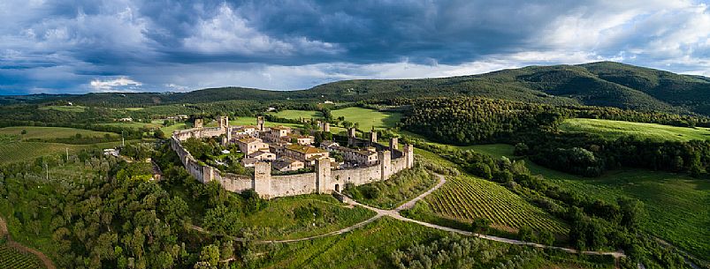 Aerial view of Monteriggioni village. It is a complete walled medieval town in the Siena Province of Tuscany built in the 13th century, Italy, Europe Aerial view of Monteriggioni village. It is a complete walled medieval town in the Siena Province of Tuscany built in the 13th century, Italy, Europe
