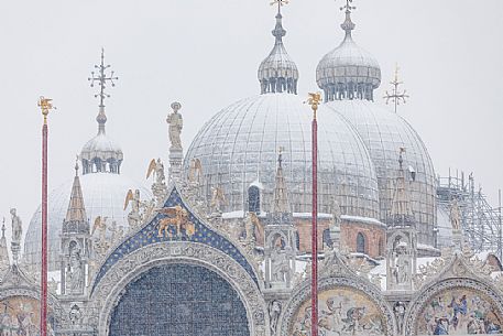 Domed roof of the Basilica San Marco church or St Mark basilica in Piazza San Marco or St Mark square in a snowy day, Venice, Italy