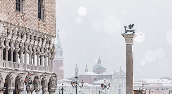 Rooftops of old buildings including Doge's Palace, Lion of Saint Mark and church of San Giorgio Maggiore. Piazza San Marco, Venice, Italy