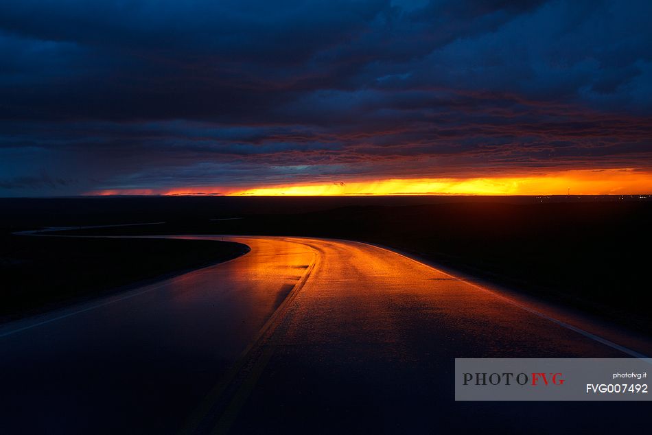 Terrifying sunset reflected on the road, Badlands National Park, South Dakota