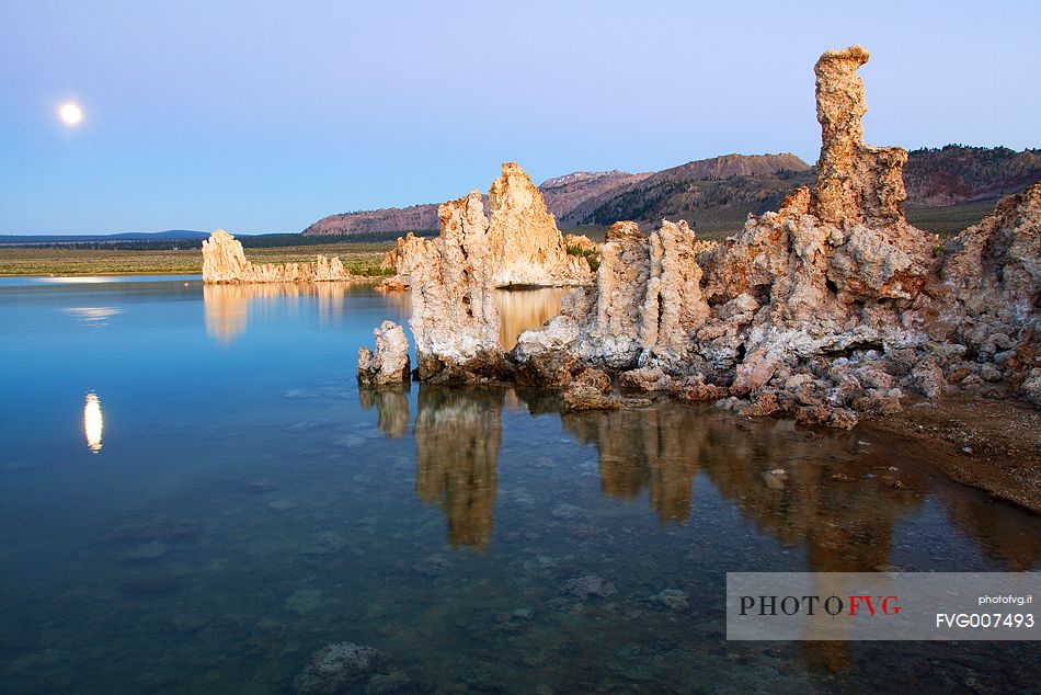 Moon at sunset and rock formation at Mono Lake, California.