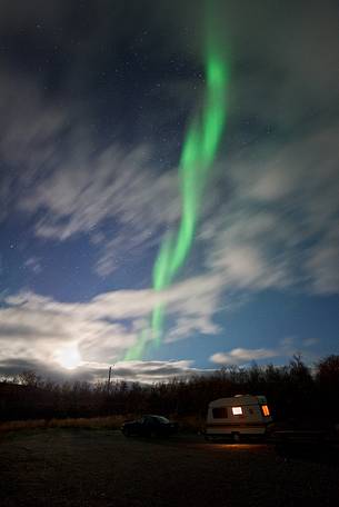 Northern lights, moon and caravan over Kilpisjrvi, Norway.
