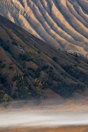 Volcanic terrain illuminated by the first light of sunrise, Bromo Tengger Semeru National Park. Volcanic terrain illuminated by the first light of sunrise, Bromo Tengger Semeru National Park.