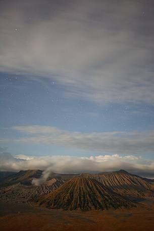 Starry night and smoking volcano, Bromo Tengger Semeru National Park, Isle of Java. Starry night and smoking volcano, Bromo Tengger Semeru National Park, Isle of Java.