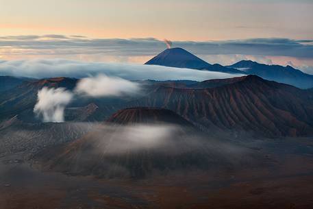 A primordial sunrise of smoking volcanoes of Bromo Tengger Semeru National Park, Isle of Java.