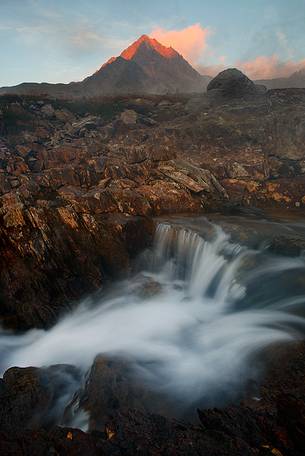 Mountain peak and river at sunset, Stelvio National Park, italian Alps.