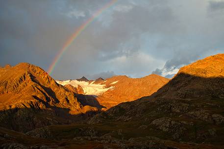 Rainbow over Doseg glacier, italian Alps.