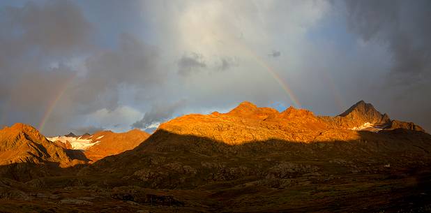 Rainbow over Doseg glacier, italian Alps.