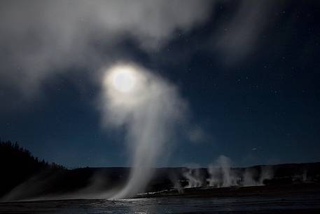 Beautiful nigh, full moon and geysers close to the Grand Prismatic Spring, Yellowstone National Park, Wyoming.