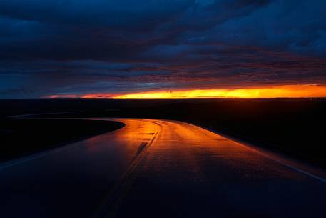 Terrifying sunset reflected on the road, Badlands National Park, South Dakota Terrifying sunset reflected on the road, Badlands National Park, South Dakota