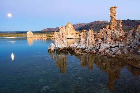 Moon at sunset and rock formation at Mono Lake, California.