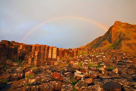 Amazing rainbow at sunset over the Giant's Causeway, Northern Ireland Amazing rainbow at sunset over the Giant's Causeway, Northern Ireland