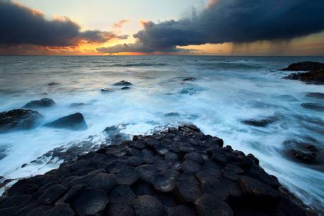 Amazing sunset and the basaltic rocks of the Giant's Causeway, Northern Ireland Amazing sunset and the basaltic rocks of the Giant's Causeway, Northern Ireland