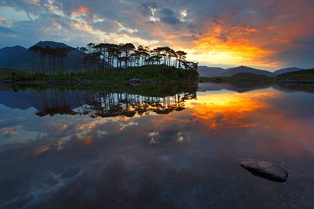 Incredible sunrise and reflection in Derryclare Lough, one of the most iconic place of Connemara, Ireland Incredible sunrise and reflection in Derryclare Lough, one of the most iconic place of Connemara, Ireland