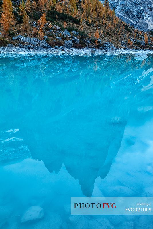 Punta Sorapiss is reflected on the Sorapiss lake, Cortina d'Ampezzo, dolomites, Italy