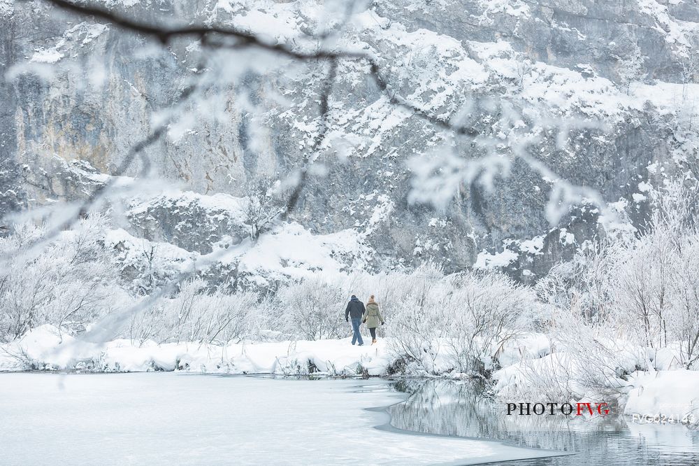 Tourists walking in the winter landscape of Plitvice Lakes National Park, Croatia
