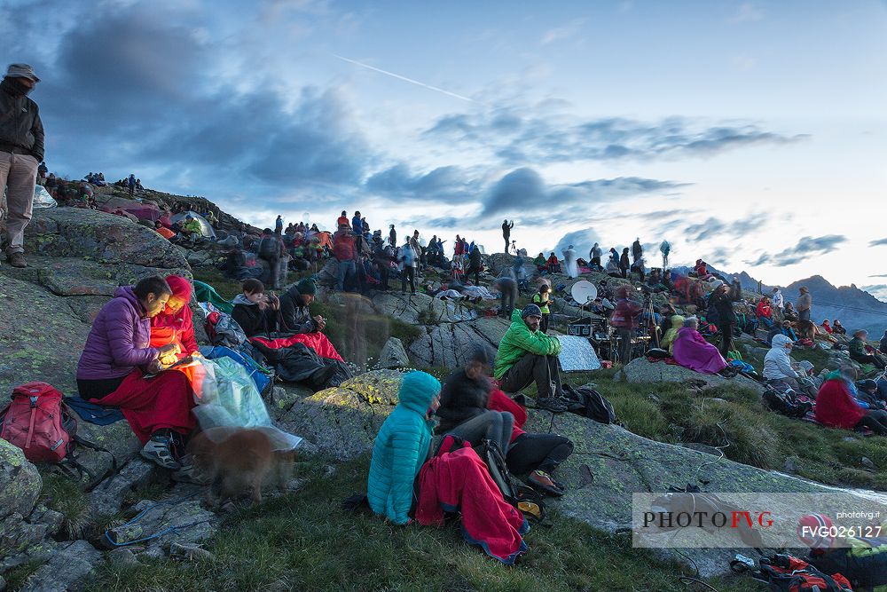 Sounds of the Dolomites, the high altitude music festival in Trentino.  At Sunrise many people listen to a concert on Col Margherita with Pale di San Martino Dolomites in background, dolomites, Italy