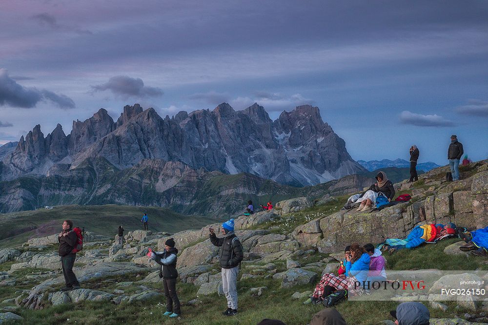 Sounds of the Dolomites, the high altitude music festival in Trentino.  At Sunrise many people listen to a concert on Col Margherita with Pale di San Martino Dolomites in background, dolomites, Italy