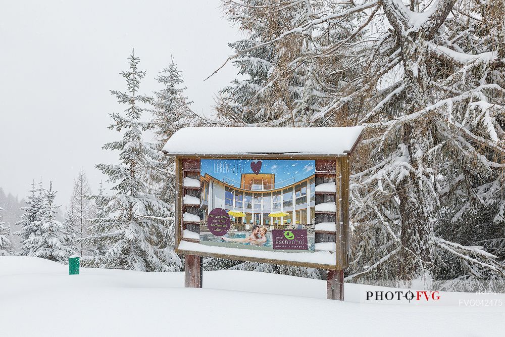Advertising billboard for the spa along the natural snowy trail, Bad Kleinkirchheim, Carinthia, Austria, Europe


