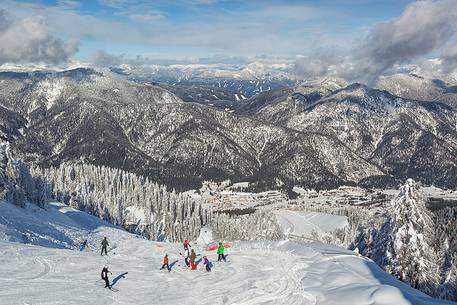 The plain of Camporosso from Mount Lussari with skiers