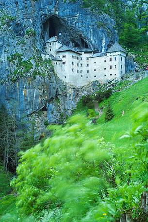 Predjama Castle emerging from its cave
