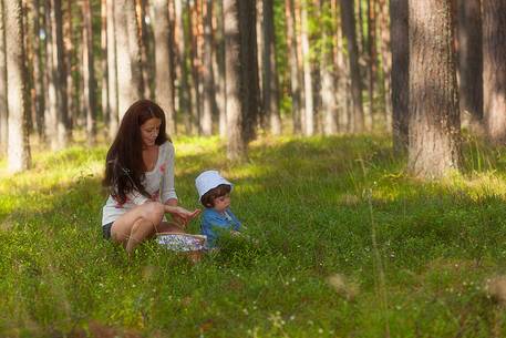 mother and son in the wild blueberry forest