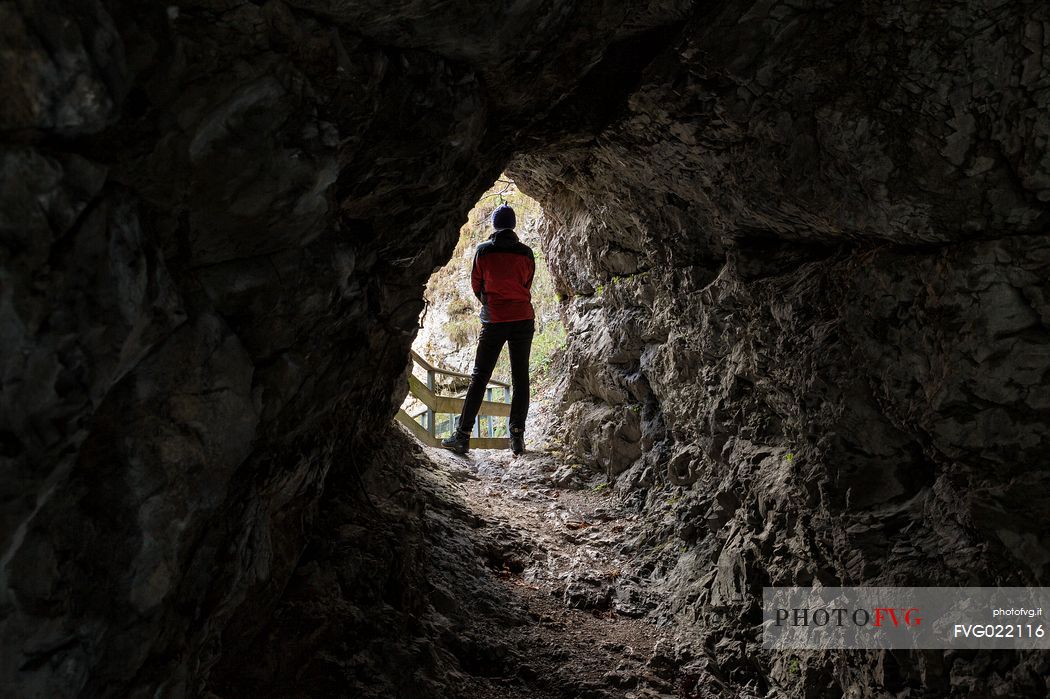 Hiker in the Cave of the Orrido of Slizza, Julian Alps, Italy Hiker in the Cave of the Orrido of Slizza, Julian Alps, Italy