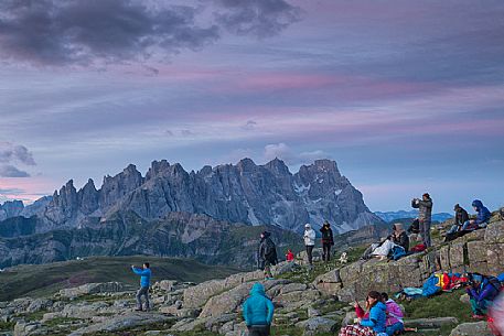 Sounds of the Dolomites, the high altitude music festival in Trentino. At Sunrise many people listen to a concert on Col Margherita with Pale di San Martino Dolomites in background, dolomites, Italy Sounds of the Dolomites, the high altitude music festival in Trentino. At Sunrise many people listen to a concert on Col Margherita with Pale di San Martino Dolomites in background, dolomites, Italy