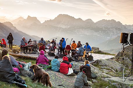 Sounds of the Dolomites, the high altitude music festival in Trentino.  At Sunrise many people listen to a concert on Col Margherita, dolomites, Italy