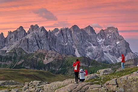 Hikers admire the Pale di San Martino mountains, Col Margherita, Trentino, Italy