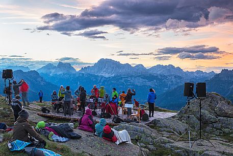 Sounds of the Dolomites, the high altitude music festival in Trentino.  At Sunrise many people listen to a concert on Col Margherita, dolomites, Italy