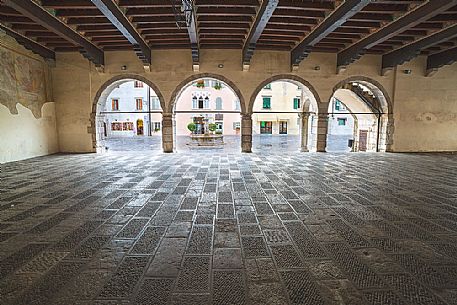 Loggia of Venzone village. It was declared National Monument in 1965 as unique fortified village of the XIV century in the region, Friuli Venezia Giulia, Italy Loggia of Venzone village. It was declared National Monument in 1965 as unique fortified village of the XIV century in the region, Friuli Venezia Giulia, Italy