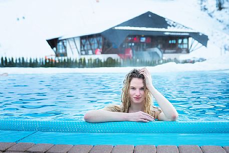 Relax in the Thermal Romerbad alpine wellness and in the background the World cup ski slope, Bad Kleinkirchheim, Carinthia, Austria, Europe 