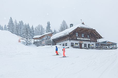Skiers in front of Maibrunnhtte mountian hut on the top of Maibrunnbahn alpine station, Bad Kleinkirchheim, Carinthia, Austria, Europe