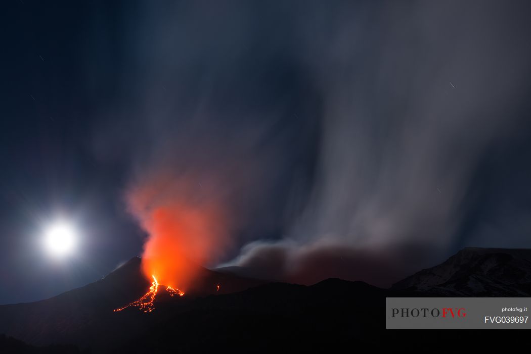 Etna and the moon in a nighttime eruption, Etna mount, Sicily, Italy, Europe