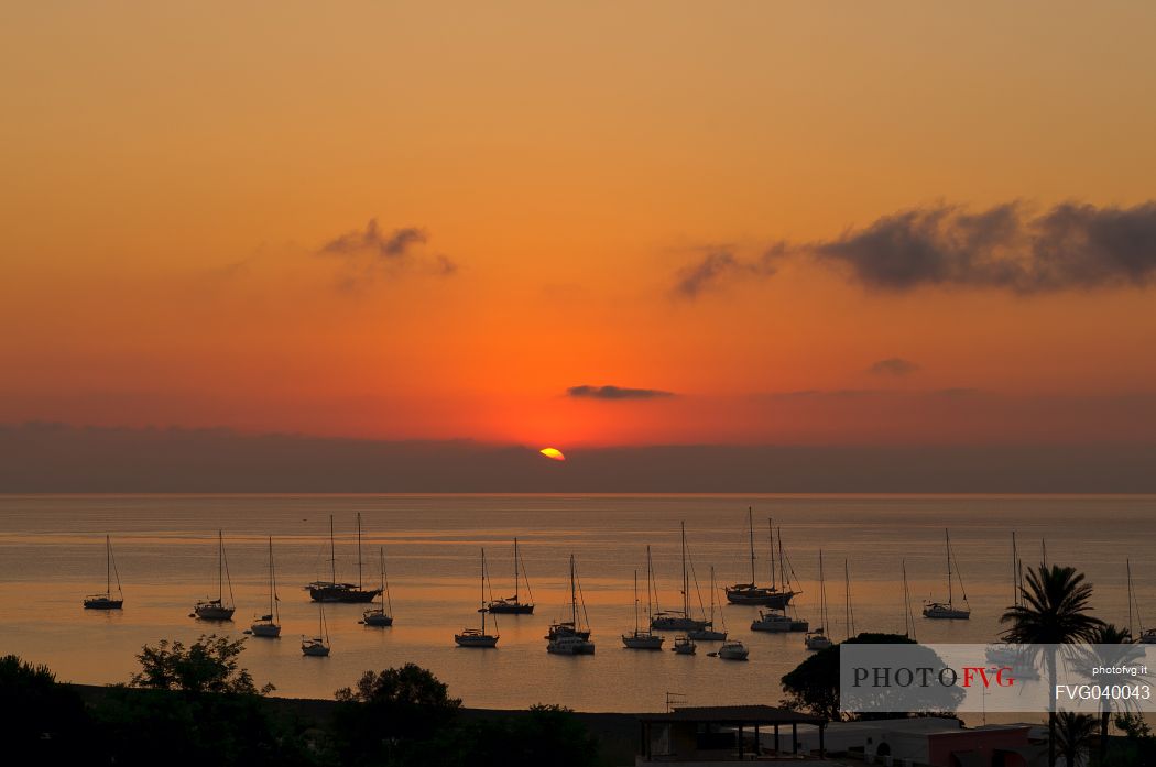 Sunset with boat in Stromboli island, Sicily, Italy