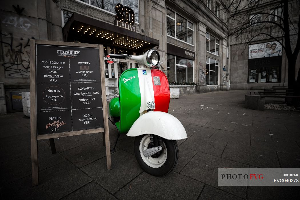 Vespa, vintage scooter stands in an alley of Warsaw, Poland