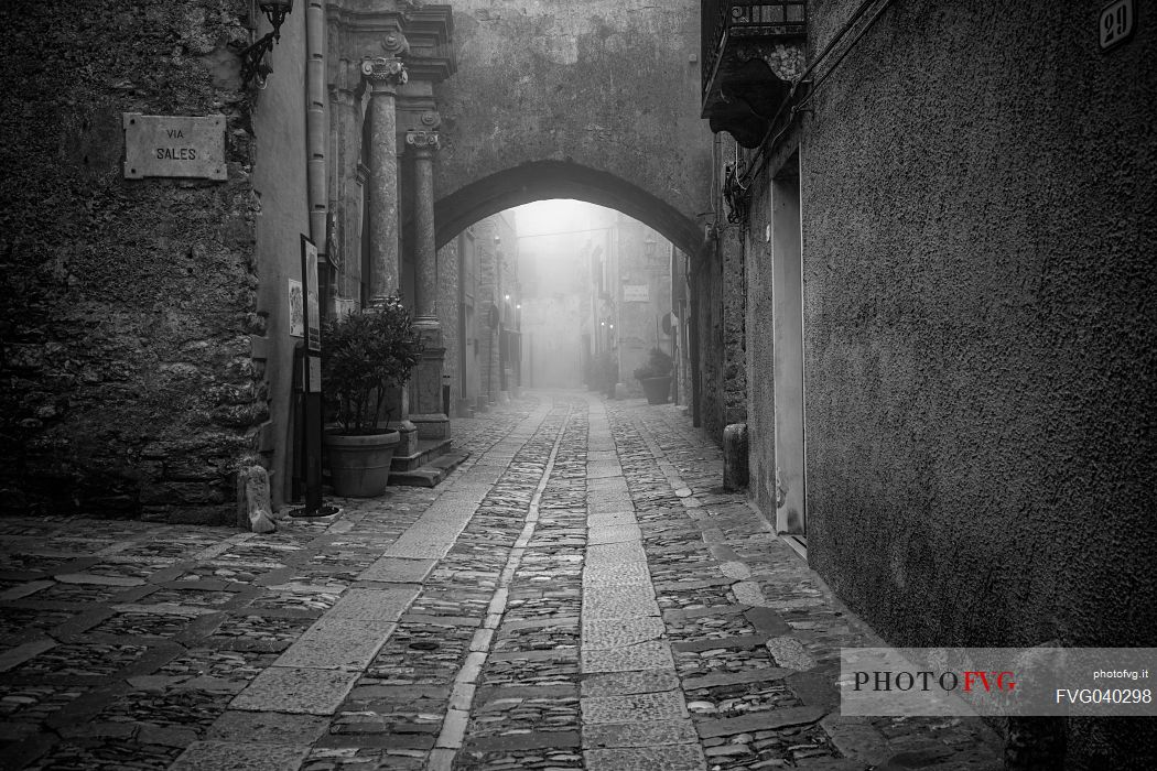 Alley in old town of Erice village in a foggy day, Sicily, Italy, Europe
