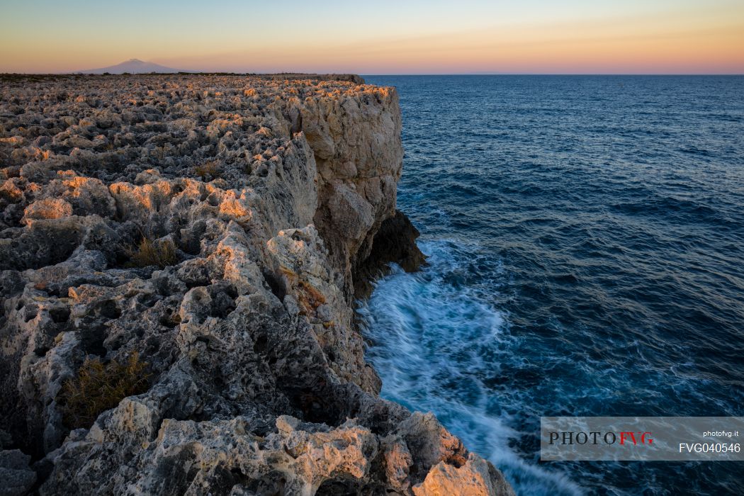 Capo Murro di Porco, Plemmirio, and in the background the Etna mount, Sicily, Italy