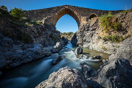 Front view of the ponte dei saraceni bridge, an ancient medieval bridge of Norman age located on the Simeto river, near Adrano, Catania, Sicily, Italy
