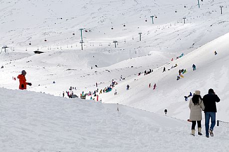 Tourist at the Silvestri craters snow covered, Etna mount, Sicily, Italy, Europe