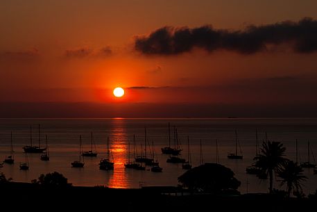 Sunset with boat in Stromboli island, Sicily, Italy