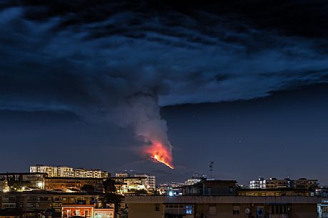 Night eruption of Etna volcano from Catania city, Sicily, Italy, Europe