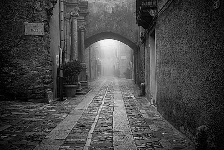 Alley in old town of Erice village in a foggy day, Sicily, Italy, Europe Alley in old town of Erice village in a foggy day, Sicily, Italy, Europe