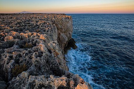 Capo Murro di Porco, Plemmirio, and in the background the Etna mount, Sicily, Italy