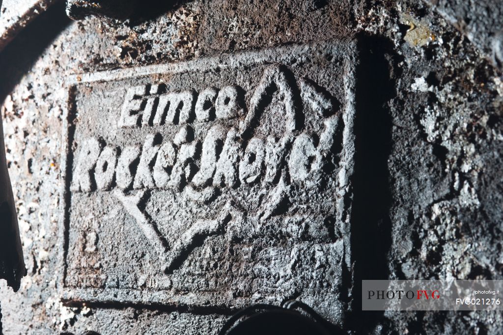 still legible plate on a compressed air excavator which is located inside the Molinello mine still in the working position. Graveglia valley, Liguria, Italy